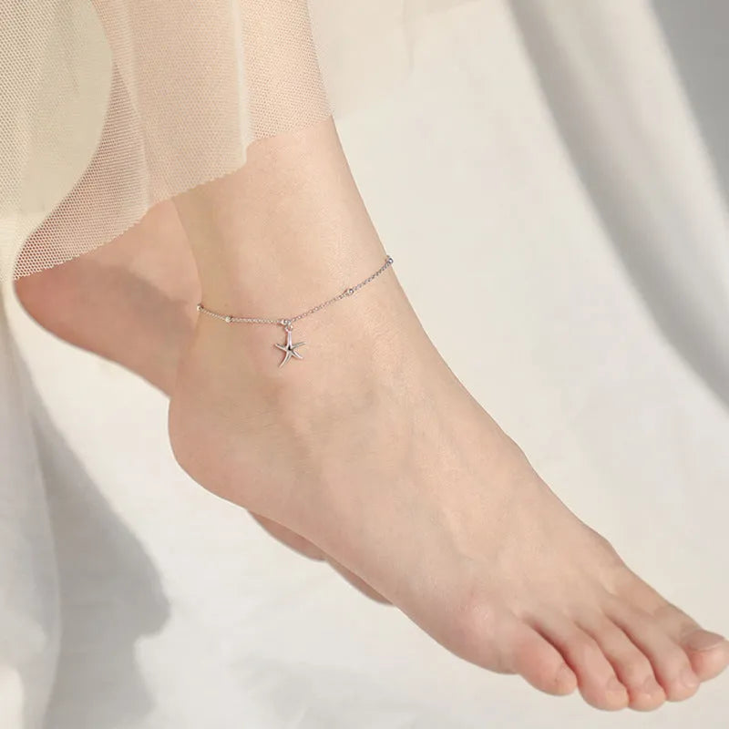 Sterling silver starfish charm anklet with round beads on an adjustable chain.
