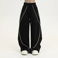 Black pleated hip hop sports pants with stripe pattern showing wide-leg design and mid-waist fit