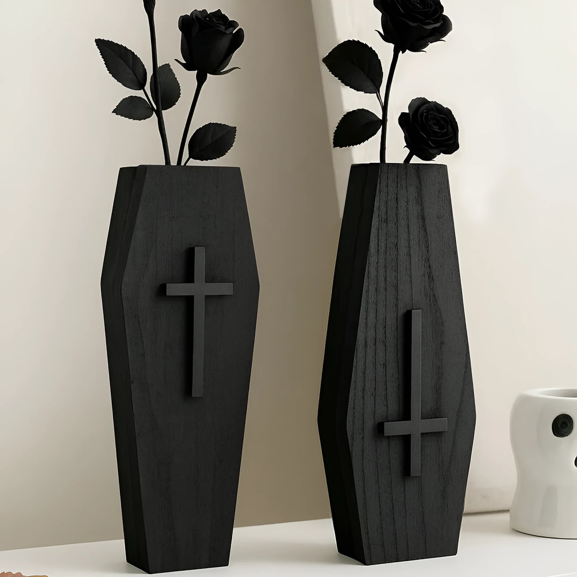 Black cross-shaped wooden wall vase shelf with a compact 27 cm ledge for holding a small vase or ornament