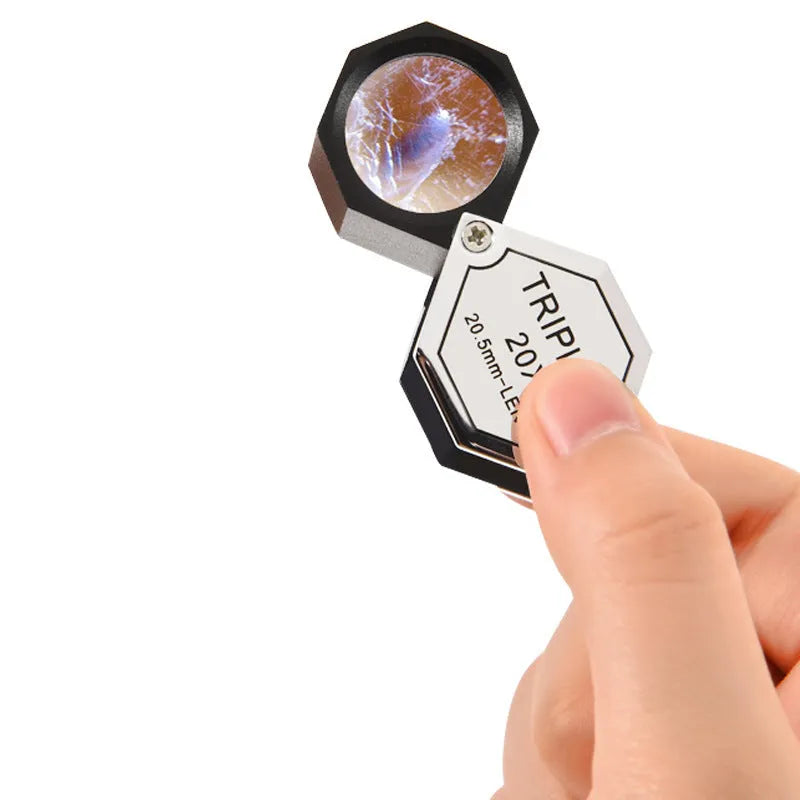 Handheld portable magnifying glass with metal housing and optical glass lens for jewellery inspection