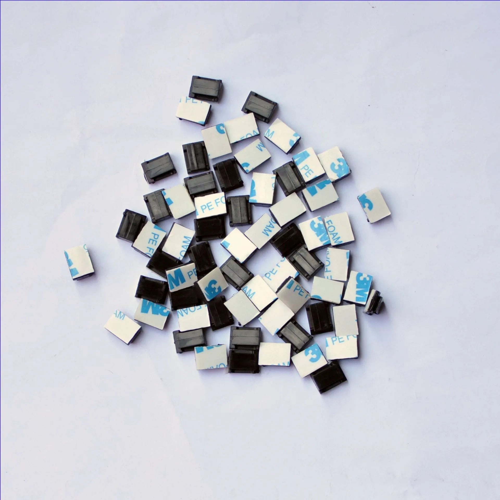 Black PA66 nylon wire management clips for automotive and electronic cable organisation