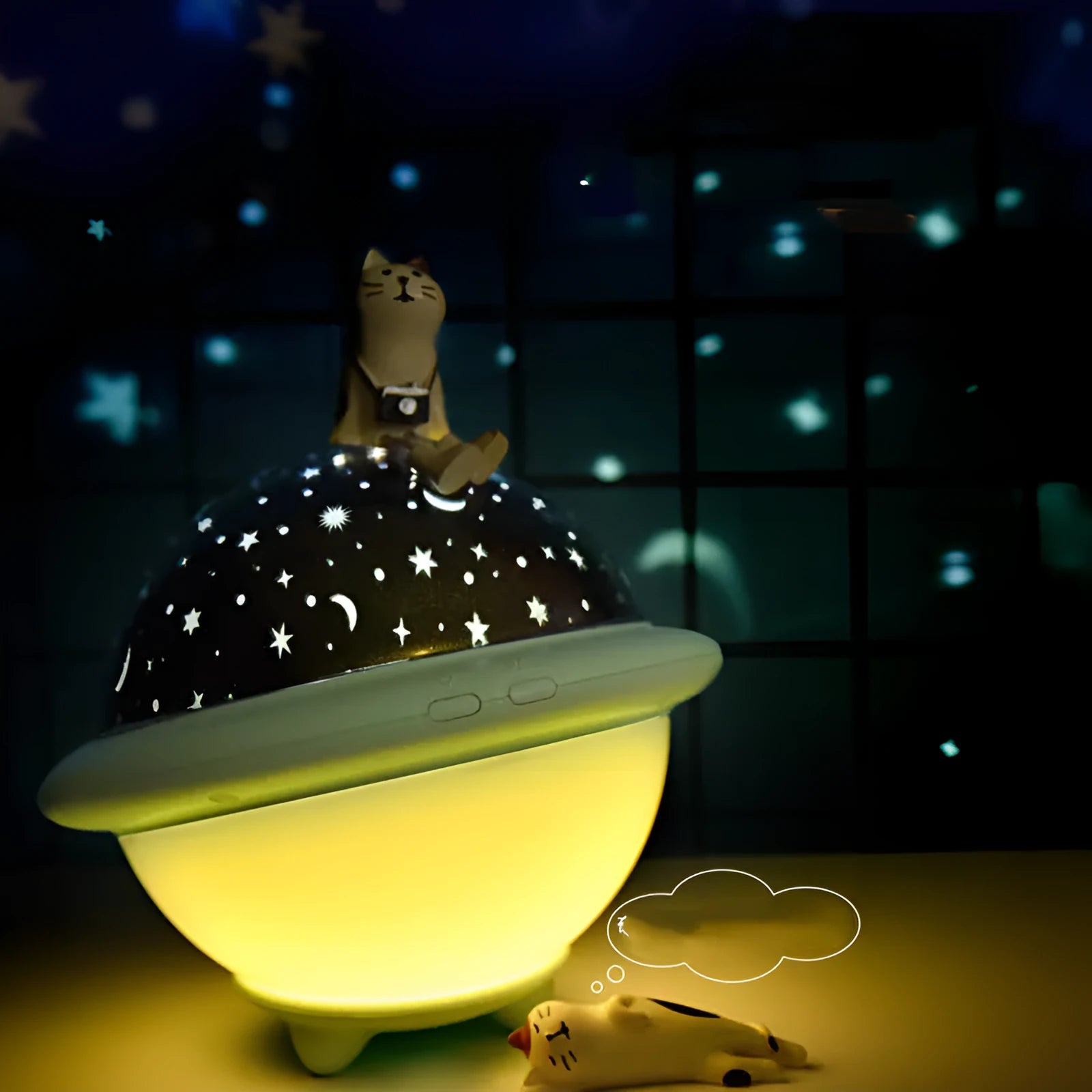 Green UFO-shaped LED star projector light showing rotating star projection on wall
