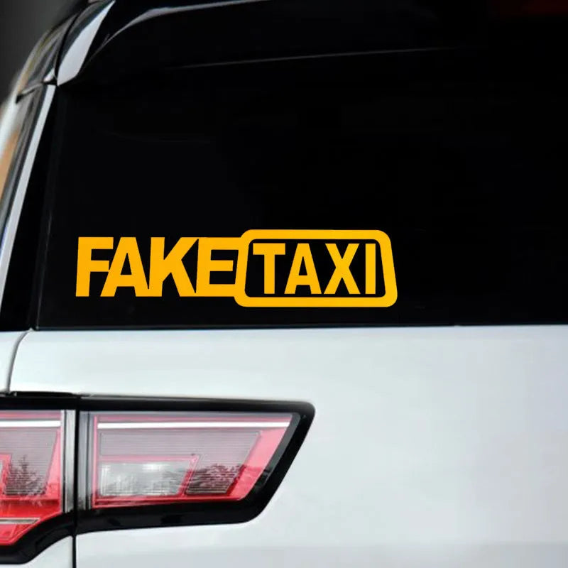 Waterproof FAKE TAXI car warning sticker in yellow, 20 cm by 8 cm, on a car window.