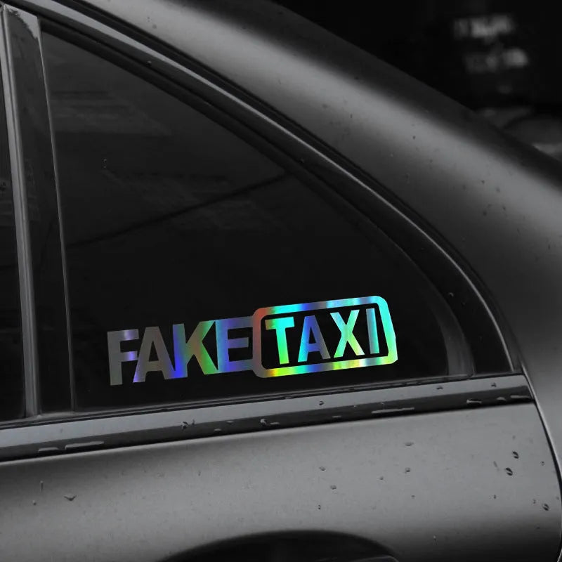 Waterproof FAKE TAXI car warning sticker in yellow, 20 cm by 8 cm, on a car window.