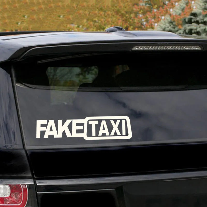 Waterproof FAKE TAXI car warning sticker in yellow, 20 cm by 8 cm, on a car window.