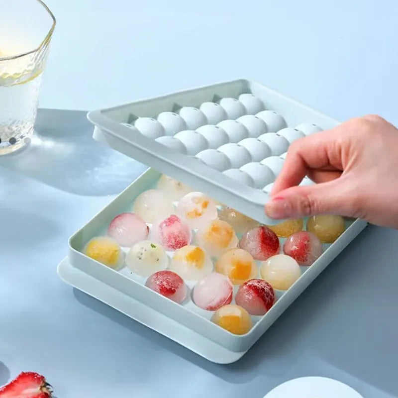 Blue silicone ice cube tray with lid showing 33 round grids for large ice cubes
