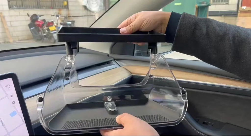 White ABS plastic storage box fitted under the screen of a Tesla Model 3 for small items