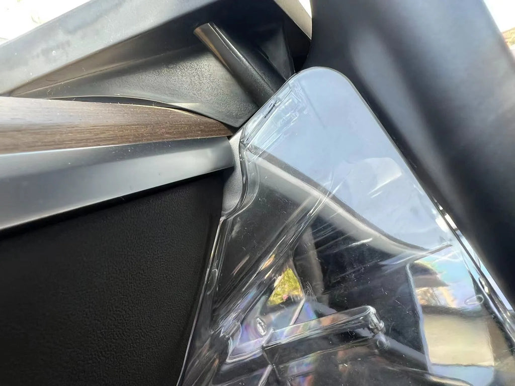 White ABS plastic storage box fitted under the screen of a Tesla Model 3 for small items