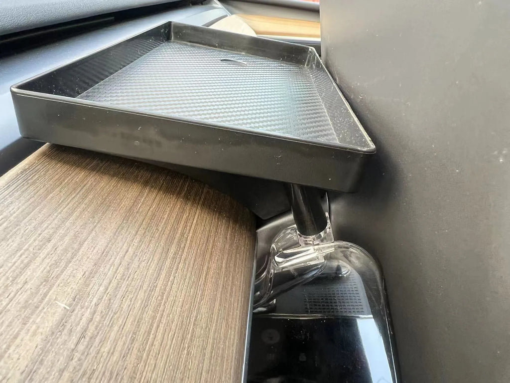 White ABS plastic storage box fitted under the screen of a Tesla Model 3 for small items