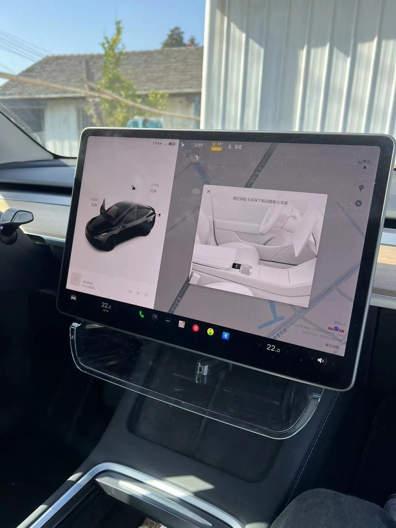 White ABS plastic storage box fitted under the screen of a Tesla Model 3 for small items
