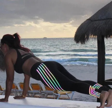 Women's black workout leggings with night-glowing print patterns, high-waisted pencil pants design