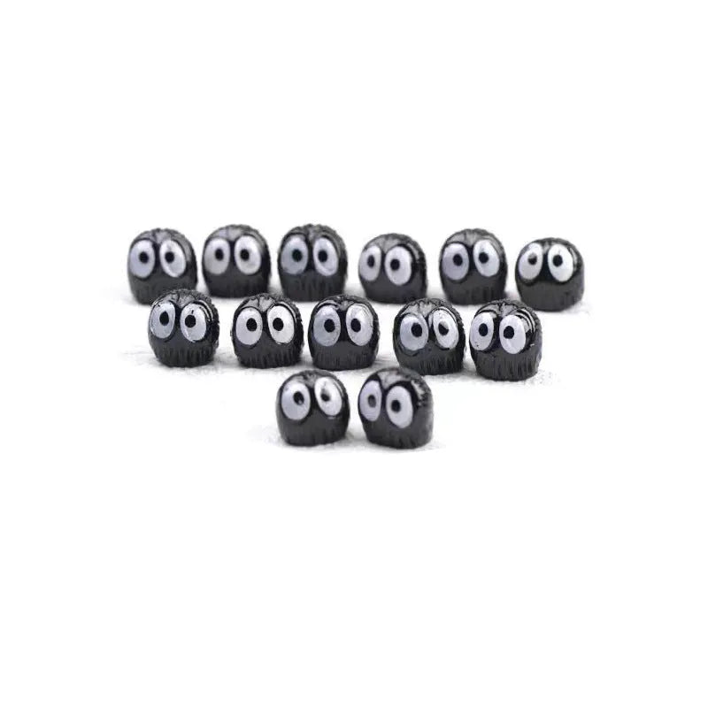 Small black cartoon-style briquette car decoration made of resin with adhesive tape.