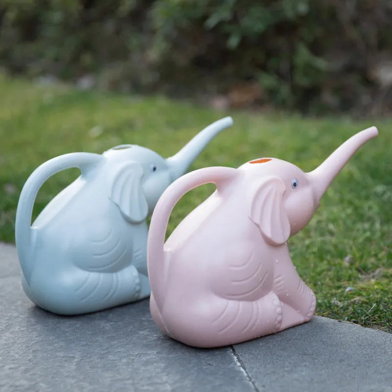 Pink elephant-shaped plastic watering can with a long nozzle for plant watering.