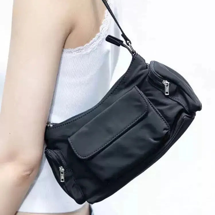 Black lightweight PU shoulder bag with two pockets and side-line detailing.