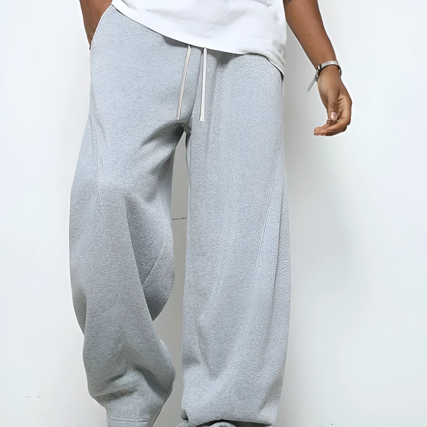 Men's grey casual trousers with drawstring waist and straight leg design on hanger