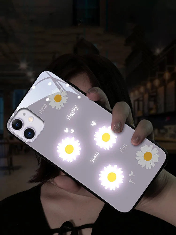 White Apple iPhone case with painted daisy pattern and illuminated voice-activated colour light on display.