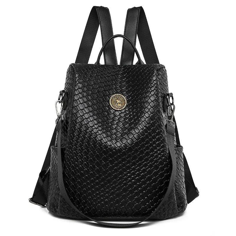 Women's large capacity anti-theft backpack in black PU material with contrast stitching and woven accents for travel