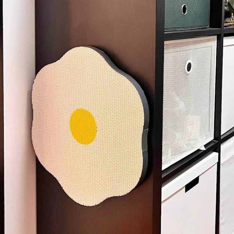 Grey wall-mounted cat scratching board with corrugated surface attached to a door using adhesive