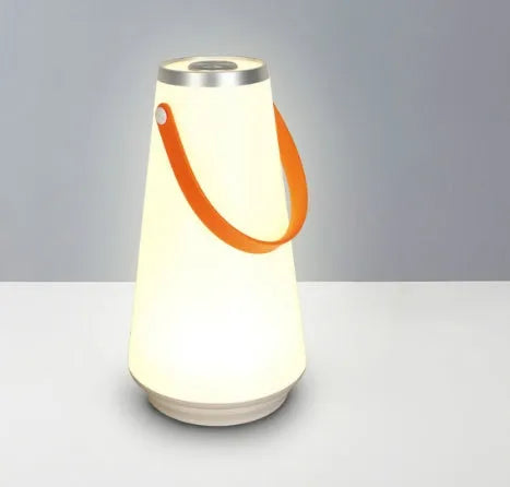 White rechargeable LED night light lantern on bedside table measuring 12x12x22cm with warm light