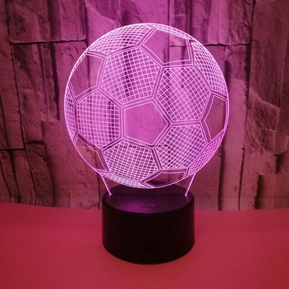 3D acrylic football night light on a square black base, showing multi-coloured LED illumination.