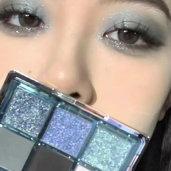 MUGELEEN nine-colour eye shadow palette showing earth tones with blue smoked variations