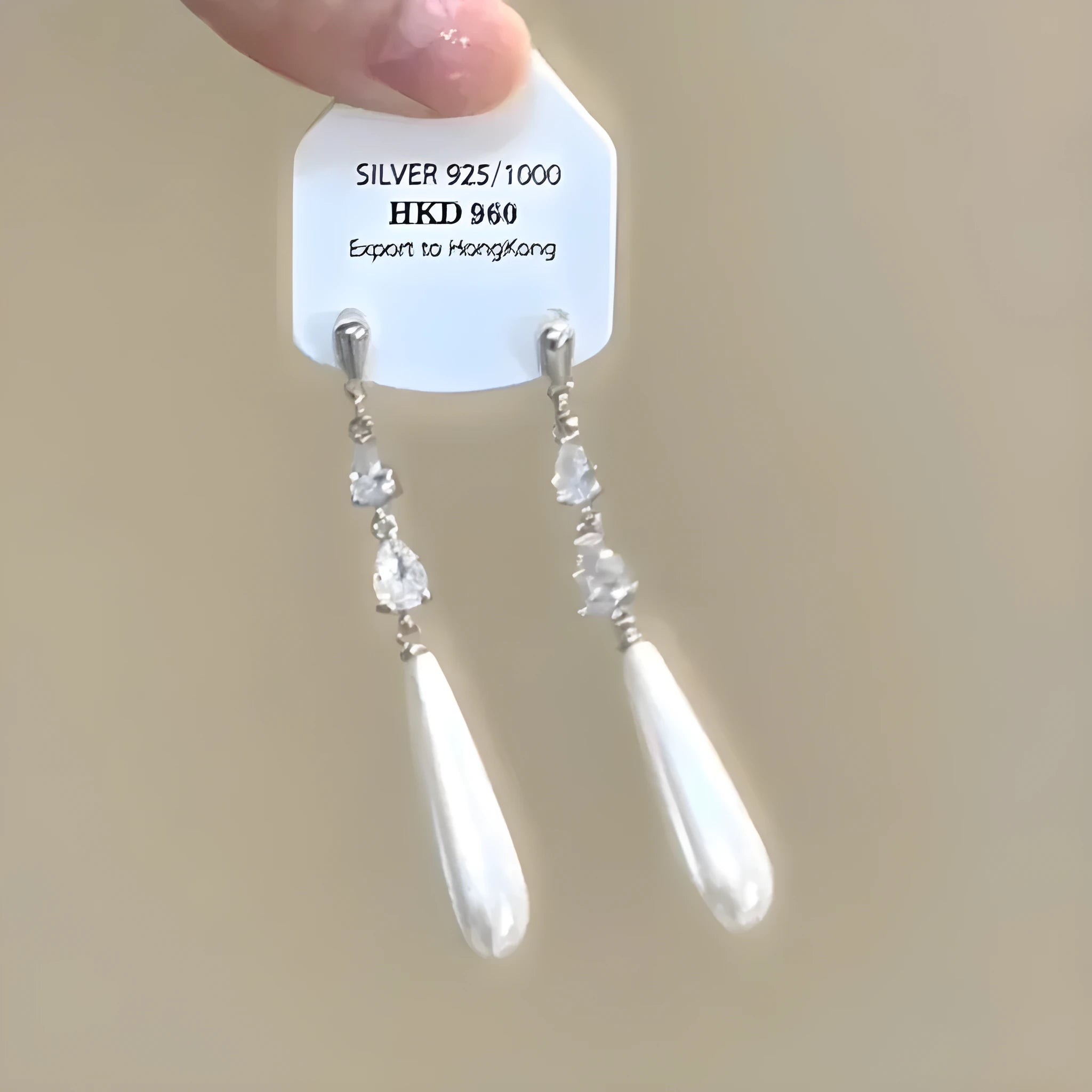 Geometric heart-shaped women's alloy earrings with rhinestones and a tassel, shown in stud and clip-on styles.