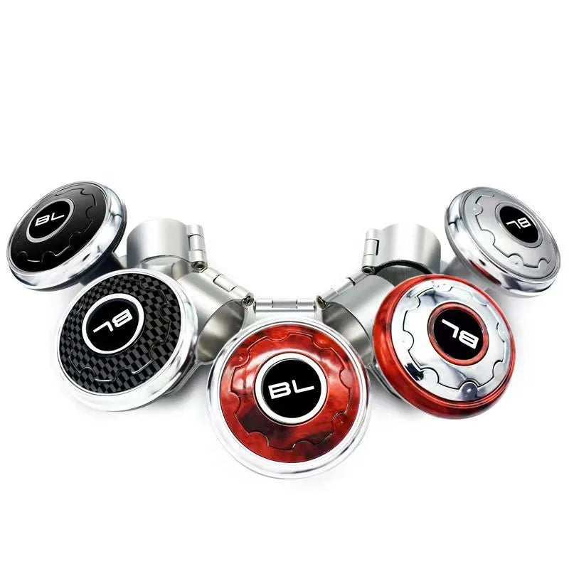 Metal universal steering wheel assist ball with steel ball bearing in silver finish mounted on a car steering wheel for one-handed control