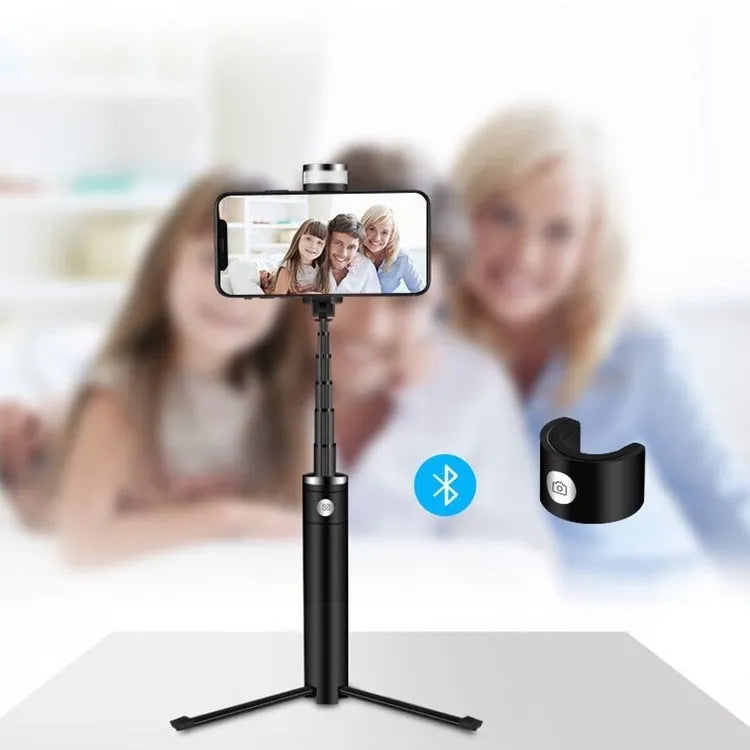 Black 7-in-1 desktop lamp selfie stick with LED lights, Bluetooth remote, and built-in tripod on a table