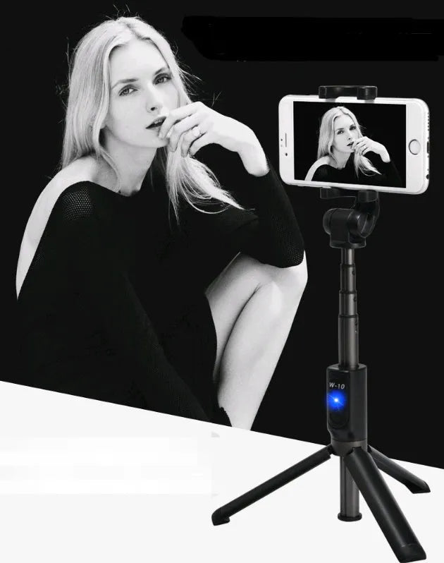 Black Bluetooth selfie stick tripod with remote control extended, holding a smartphone