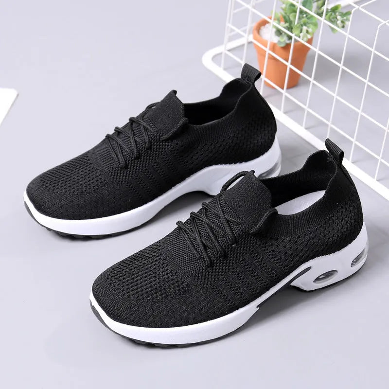 Women's black mesh lace-up sneakers with a round toe and soft PVC sole on a white background.