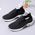 Women's black mesh lace-up sneakers with a round toe and soft PVC sole on a white background.