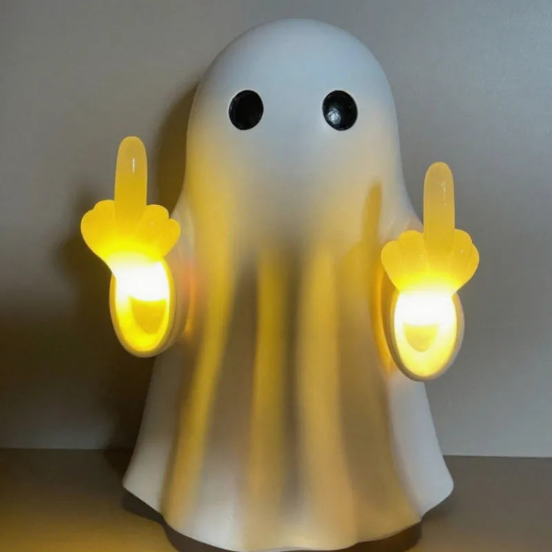 White plastic ghost night lamp with light on, on a flat surface