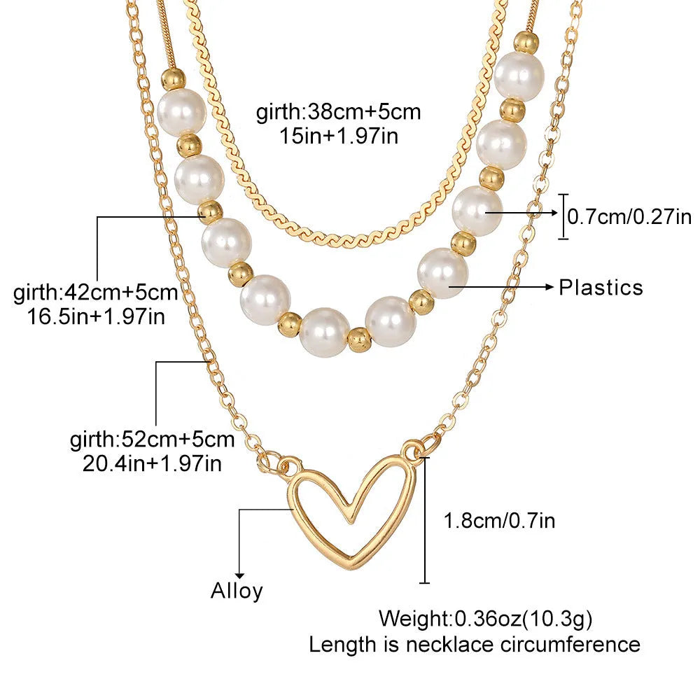 Vintage love heart pearl gold necklace with electroplated alloy pendant and adjustable pearl chain on a white background