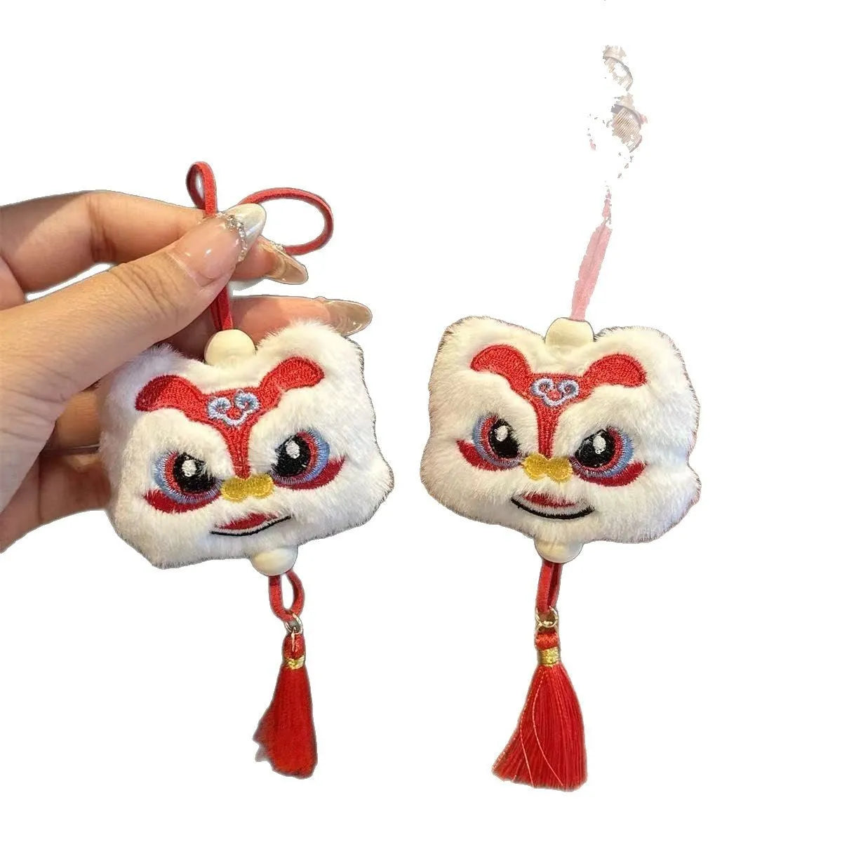 Blue and yellow Chinese style cartoon plush lion keychain ornaments with tassels and a star stone.