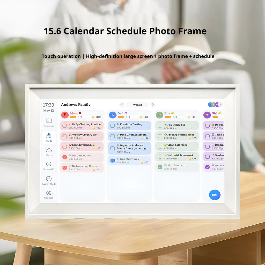 White 15.6 inch smart digital photo frame on a table with app control interface on a phone.