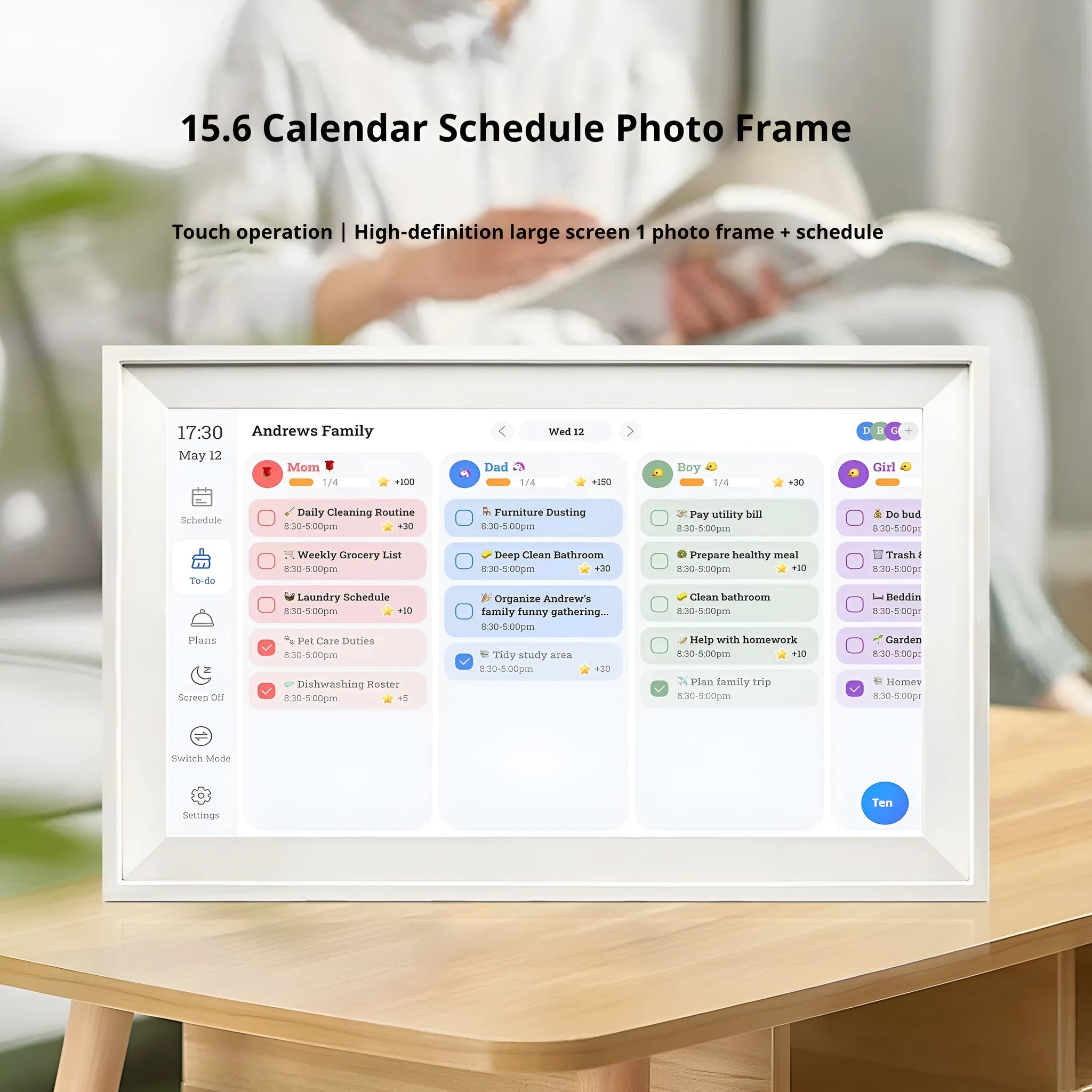 White 15.6 inch smart digital photo frame on a table with app control interface on a phone.