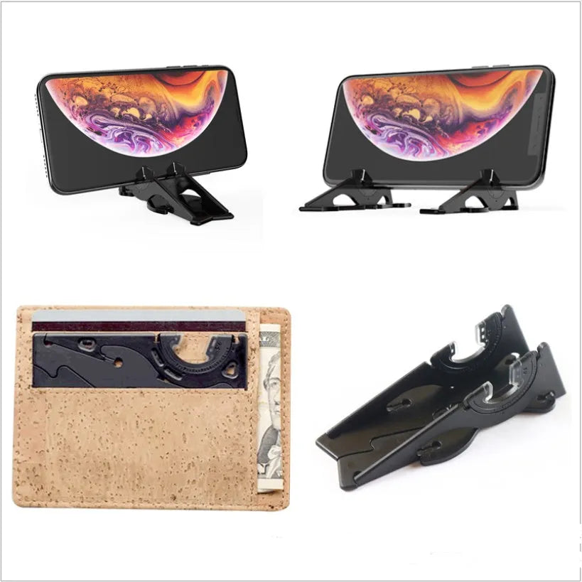 Black plastic card type mobile phone holder on desktop with smartphone