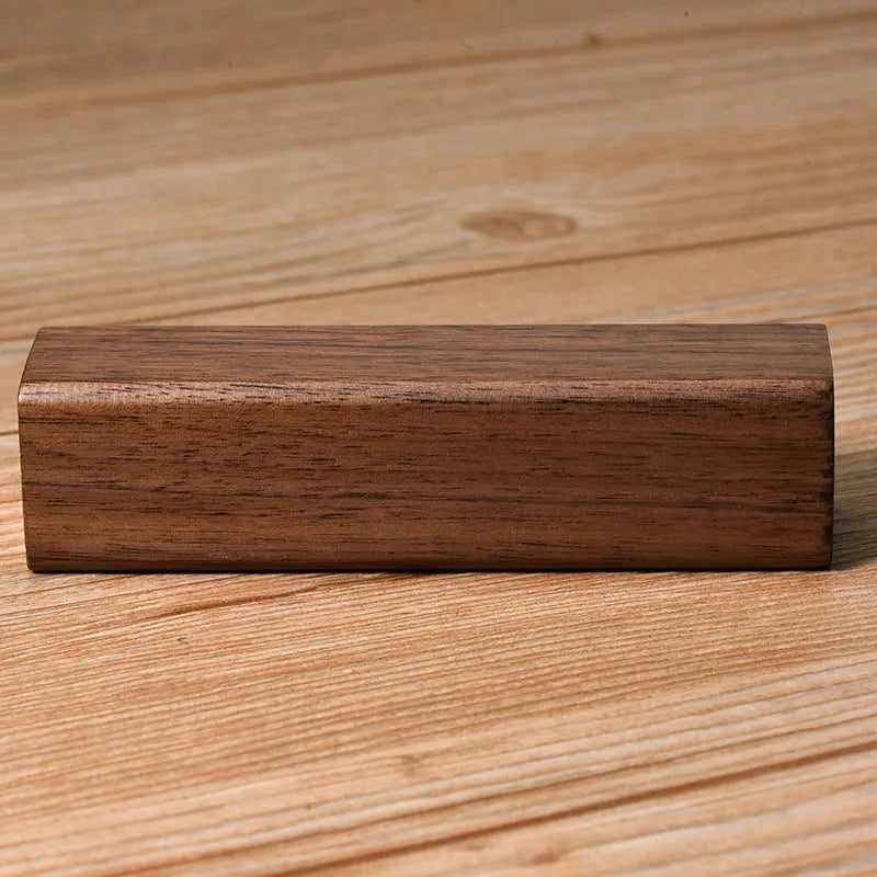 Portable black walnut solid wood power bank with 2000mAh 18650 battery, 100mm length, brown colour, on light background