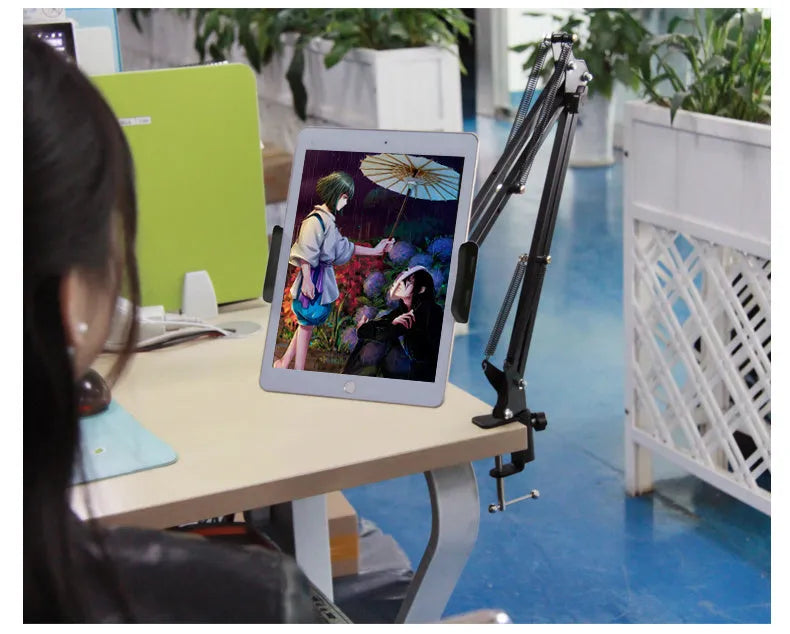Support phone tablet stand in black on a desk, holding a smartphone for hands-free viewing