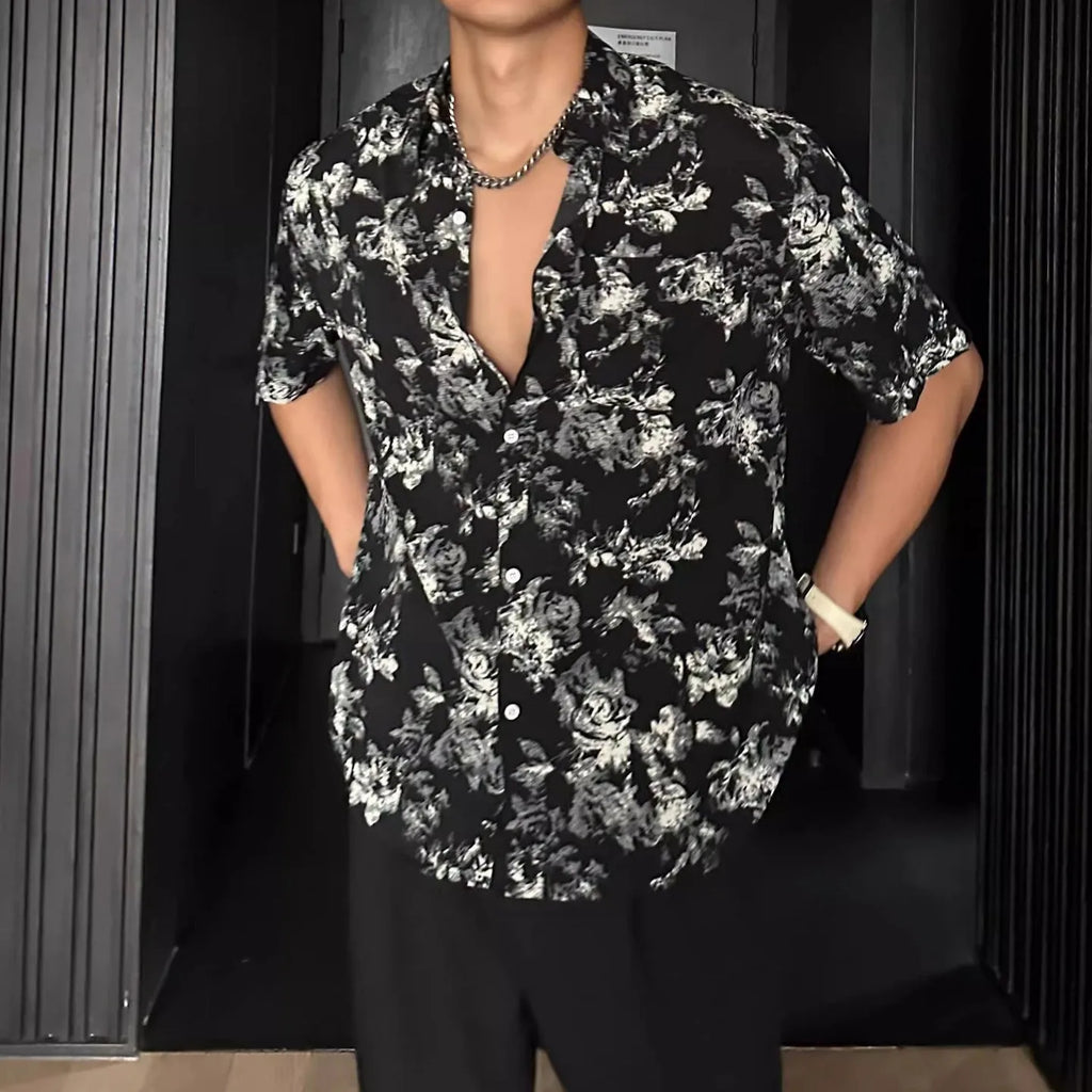 Loose black and white floral print short sleeve casual shirt on a hanger.