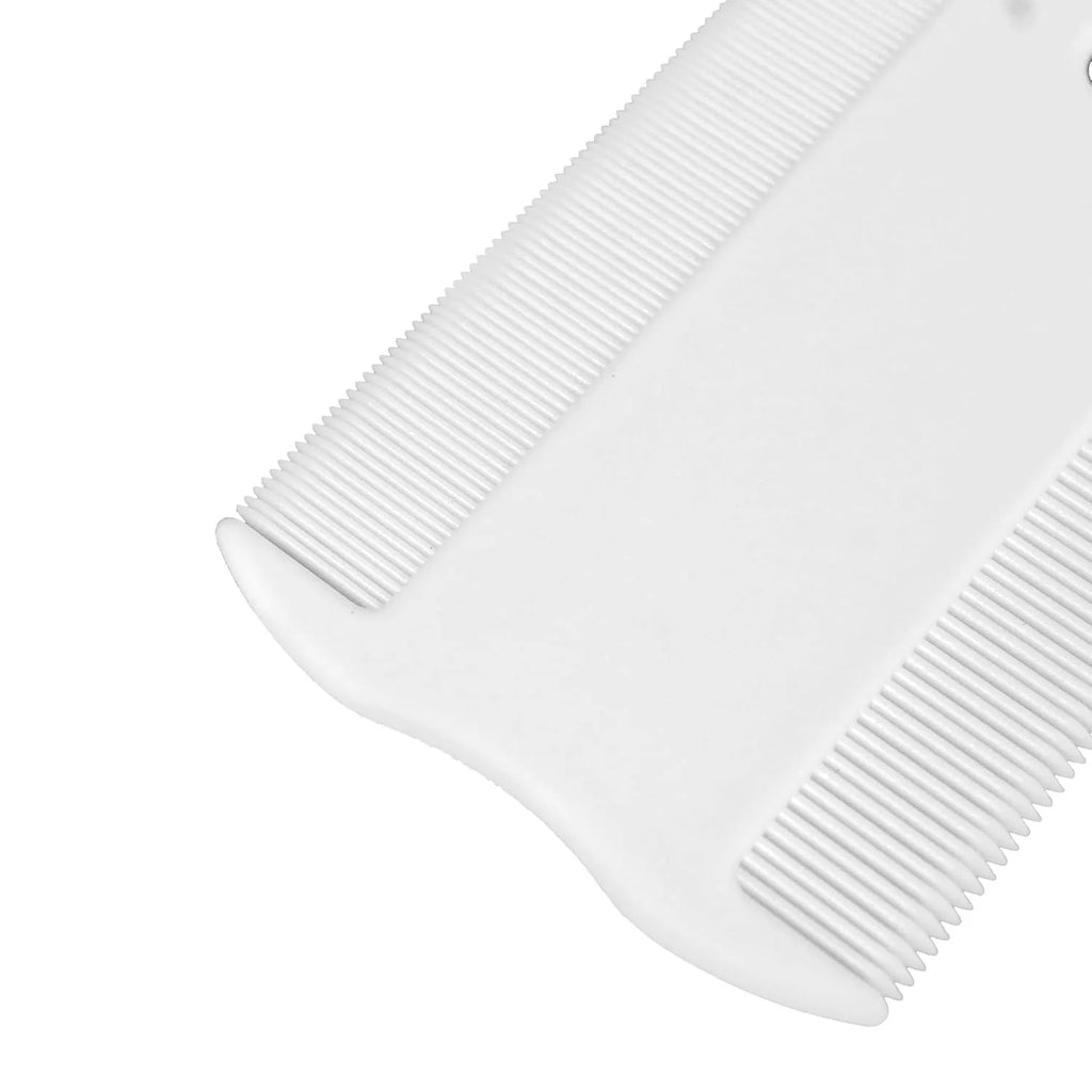 A small white plastic double-sided flea comb for pets, shown next to a ruler for scale.