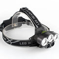Fixed focus camping head torch with long range beam on a headband, shown with its rechargeable battery and charger.