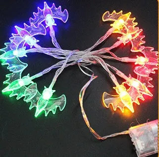 Halloween string lights with pumpkin, bat, and ghost LED lanterns hanging, showing white and coloured light options.