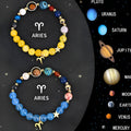 Two natural stone beaded zodiac bracelets with adjustable knots on a wooden surface.