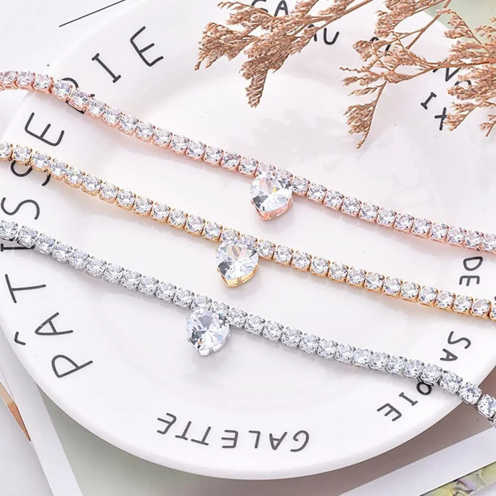 Gold rhinestone heart-shaped decorative collar for a cat or dog on a white background.