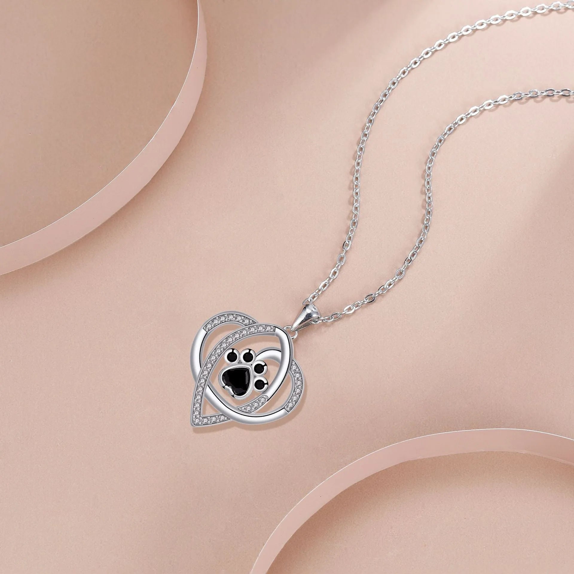 Copper necklace for women with a dog's paw print pendant on a cross chain.