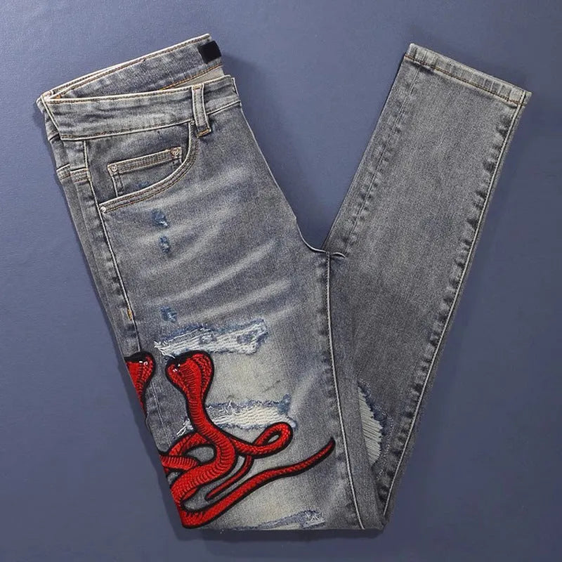 Old colour slim fit jeans with washed-out finish and embroidered hole patches