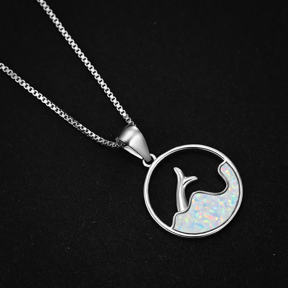 Close-up of a women's electroplated copper necklace with a geometric fishtail tail pendant in a blue opal colour.