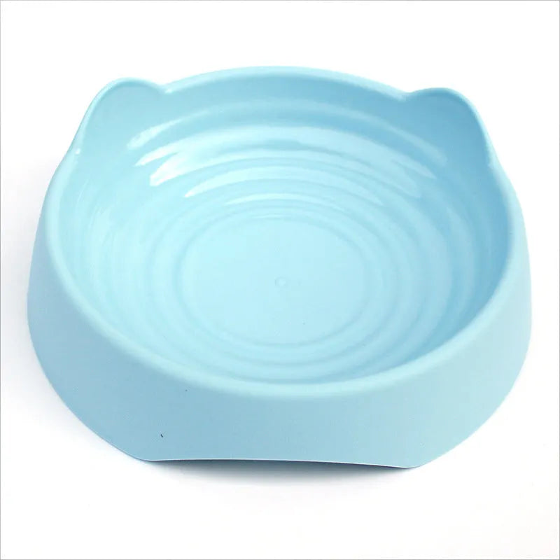 Blue ceramic dog slow feeder bowl with raised internal maze pattern for portion control