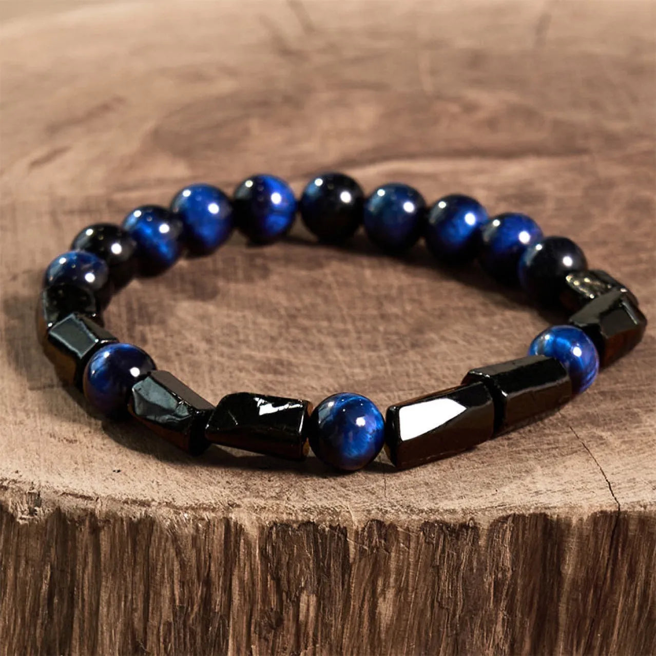 Natural obsidian single ring 8mm beaded bracelet in gold obsidian style on a plain background